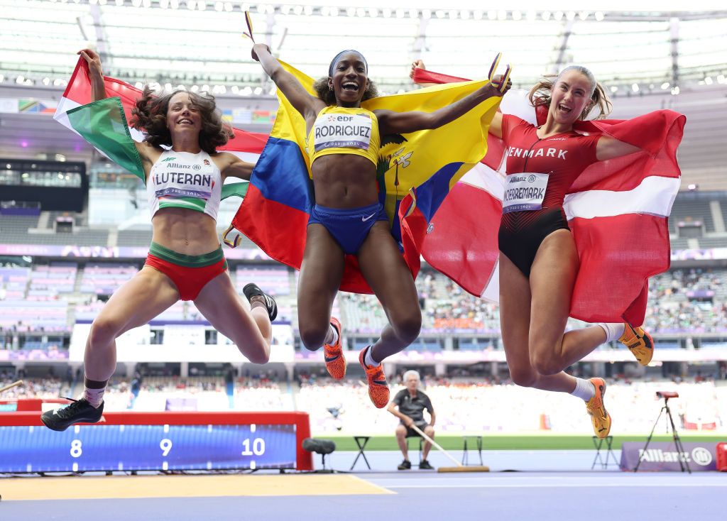 Para Athletics - Paris 2024 Summer Paralympic Games: DPARIS, FRANCE - SEPTEMBER 06: Gold medalist, Kiara Rodriguez of Team Ecuador (C), Silver medalist, Petra Luteran of Team Hungary and Bronze medalist (L), Bjoerk Noerremark of Team Denmark (R) celebrate with their national flags following victory in the Women's Long Jump T47 Final on day nine of the Paris 2024 Summer Paralympic Games at Stade de France on September 06, 2024 in Paris, France. (Photo by Ezra Shaw/Getty Images)