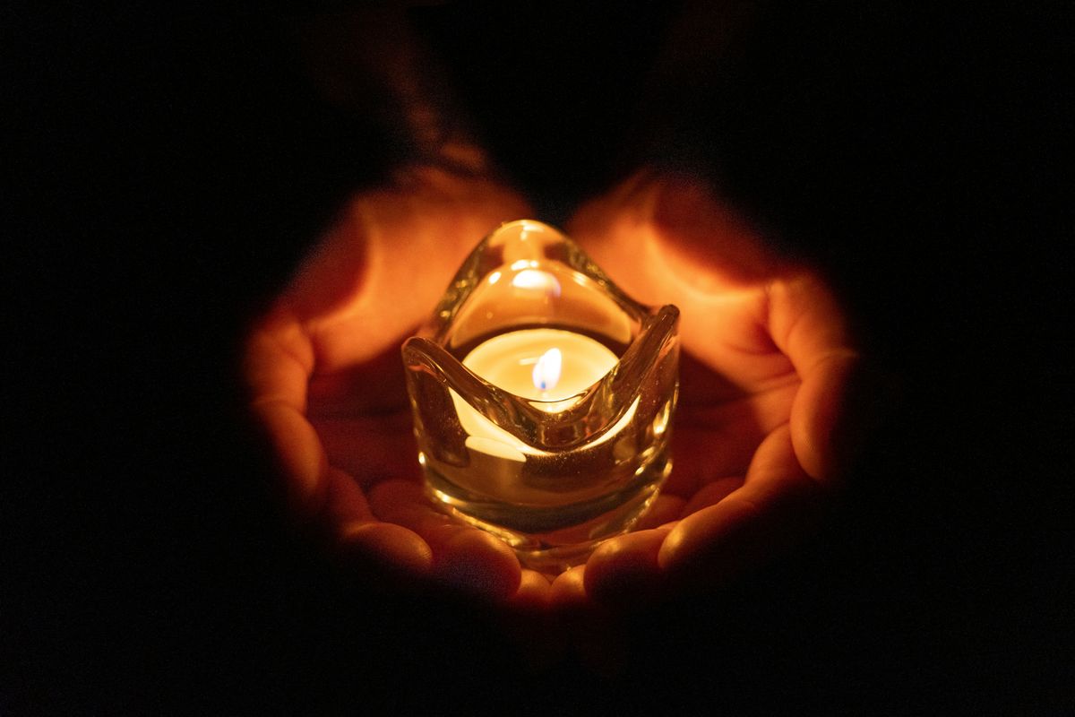 Human,Palm,Hands,Holding,Burning,Candle,In,Dark,Black,Background. gyertya gyász gyászhírek