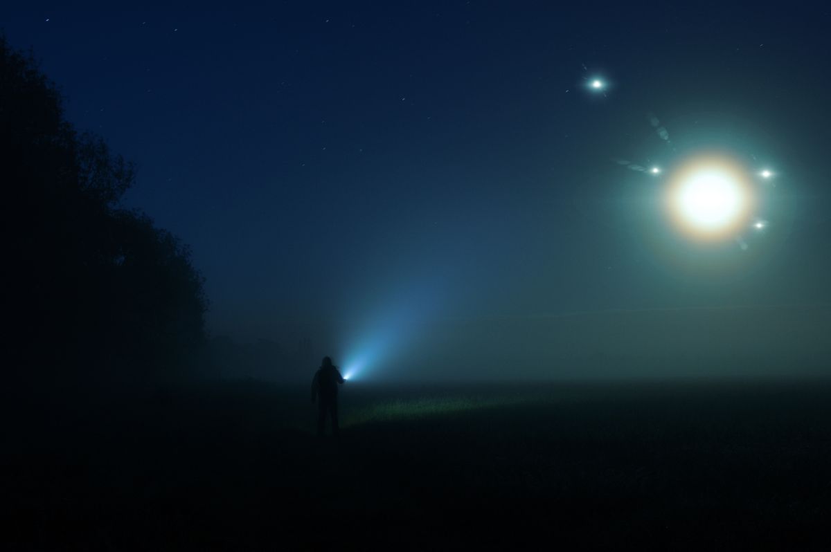 A,Man,With,A,Torch,Standing,In,The,Countryside,On, UFO