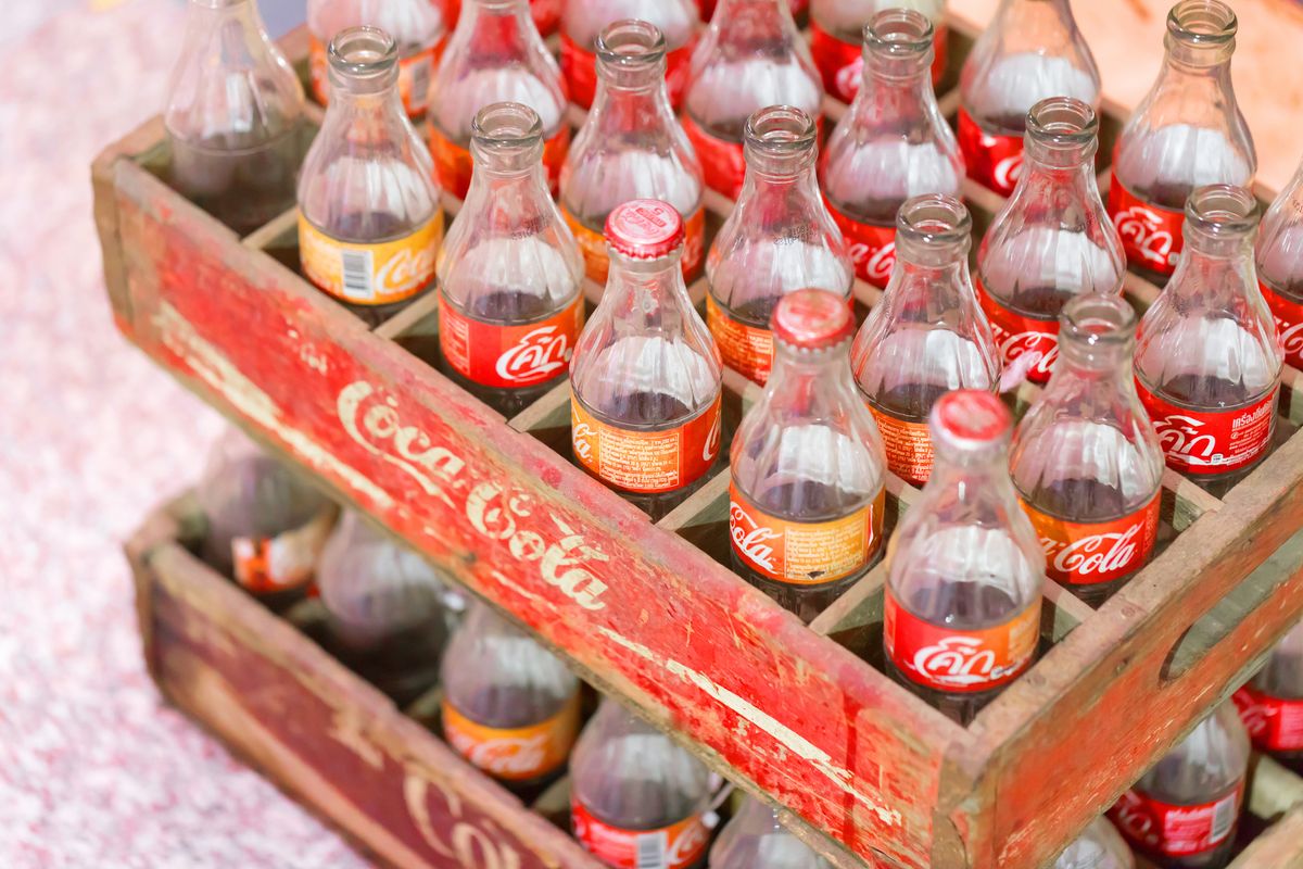 empty vintage Old retro style Coca-Cola glass bottle in wooden box sold in Thailand