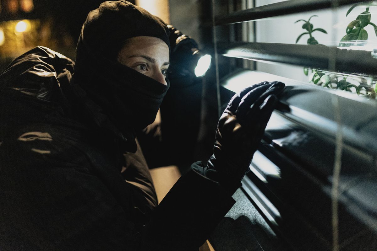 Masked thief trying to break in